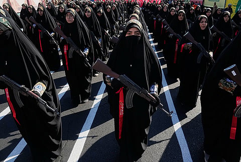 Women affiliated with Iran's Revolutionary Guard carry rifles as they stand during the state-organized "Janfada," or "Sacrifice for Iran," military-style parade in Tehran, Iran, Friday, Sept. 18, 2026. 