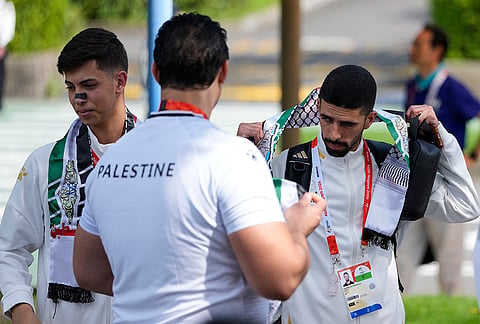 Palestinian athletes wait at the athletes village ahead of the Asian Games in Nagoya, Japan, Friday, Sept. 18, 2026. 