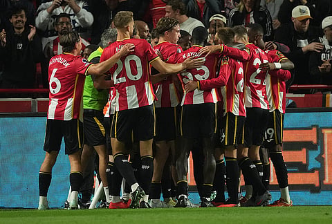 Brentford players celebrate after the first goal during the Premier League soccer match between Brentford and Chelsea in London, England, Friday, Sept. 18, 2026. 
