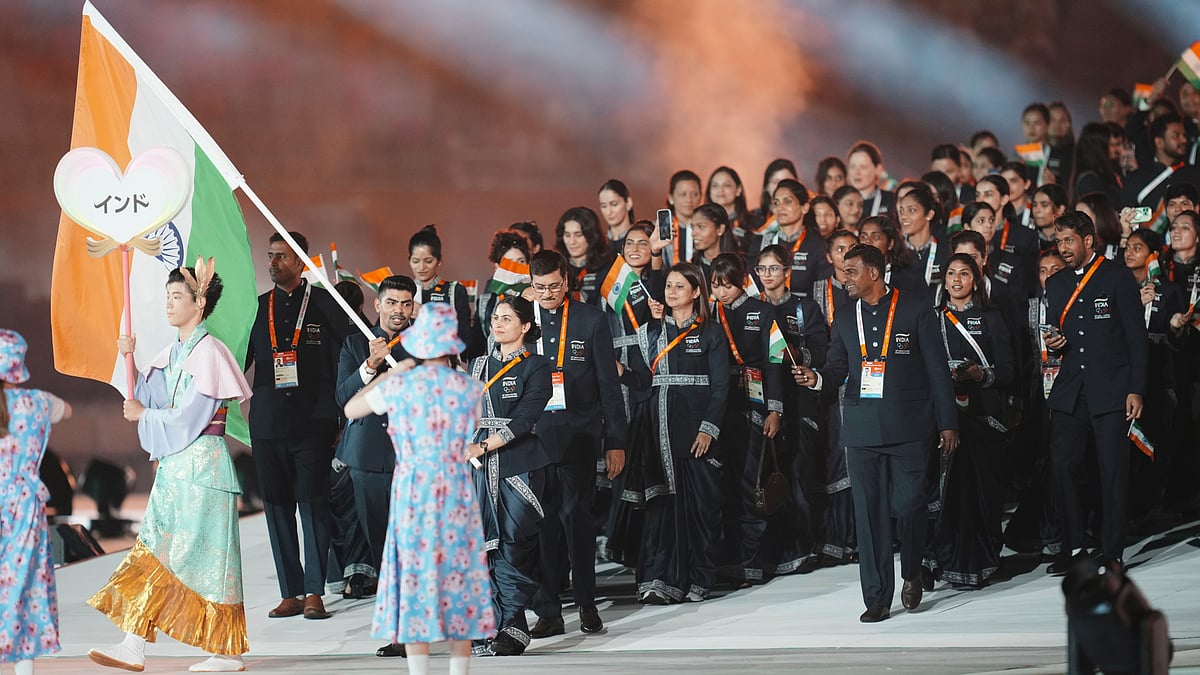 India's flag bearers Manu Bhaker and Pawan Kumar walk with teammates into the stadium during the opening ceremony for the Asian Games in Nagoya, Japan, Saturday, Sept. 19, 2026. - (AP Photo/Lee Jin-man)