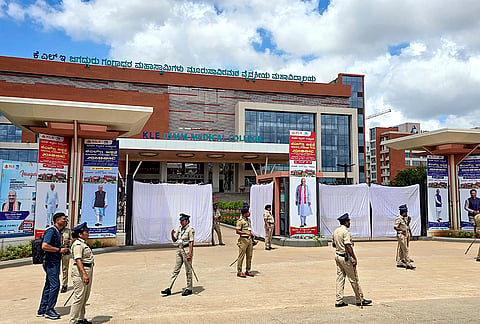 Police personnel stand guard ahead of the inauguration of KLE JGMM medical college by Union Home Minister Amit Shah, in Hubbali, Karnataka.