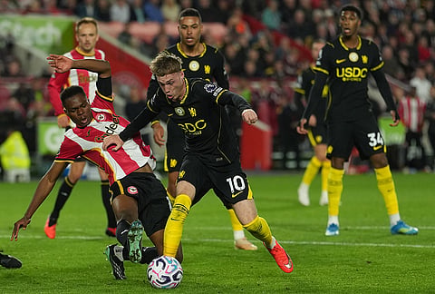 Brentford's Dango Ouattara blocks Chelsea's Cole Palmer during the Premier League soccer match between Brentford and Chelsea in London, England, Friday, Sept. 18, 2026.  