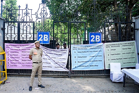 A police official stands guard outside the counting centre during the ongoing counting for the Delhi University Students' Union (DUSU) elections, in New Delhi, Saturday, Sept. 19, 2026. 
