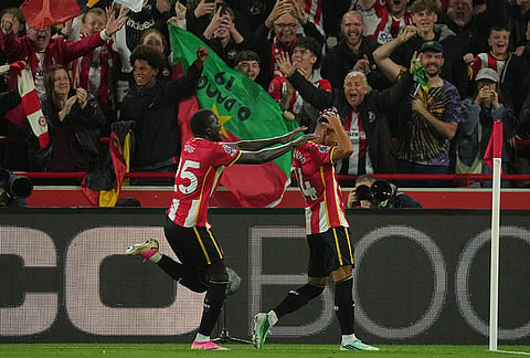 Brentford's El Hadji Diouf, left, and Fabio Carvalho celevrate third goal during the Premier League soccer match between Brentford and Chelsea in London, England, Friday, Sept. 18, 2026. 