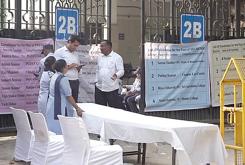 Security personnel and officials during the counting of vote for the Delhi University Students’ Union (DUSU) elections as it gets underway amid heightened security, in New Delhi, Saturday, Sept. 19, 2026. 
