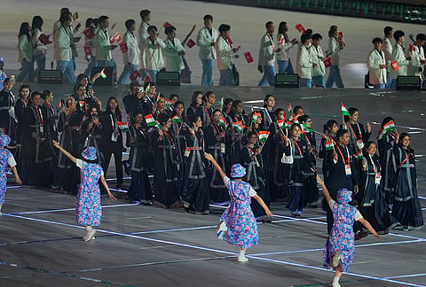 Indian athletes react as they walk into the stadium during the opening ceremony for the Asian Games in Nagoya, Japan, Saturday, Sept. 19, 2026. 
