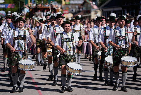 Musicians wear traditional costumes in the Oktoberfest parade at the 191st Oktoberfest beer festival in Munich, Germany, Saturday, Sept.19, 2026. 
