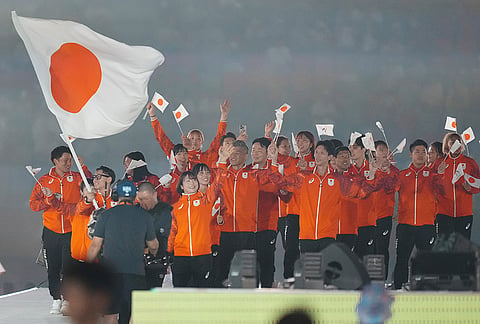 Japan's flag bearers Fujinami Akari and Nakamura Rimu walk wit teammates into the stadium during the opening ceremony for the Asian Games in Nagoya, Japan, Saturday, Sept. 19, 2026. 