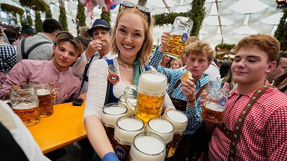 A waitress carries beer mugs after the opening of the 191st Oktoberfest beer festival in Munich, Germany, Saturday, Sept.19, 2026. 
 - | Photo: AP/Matthias Schrader