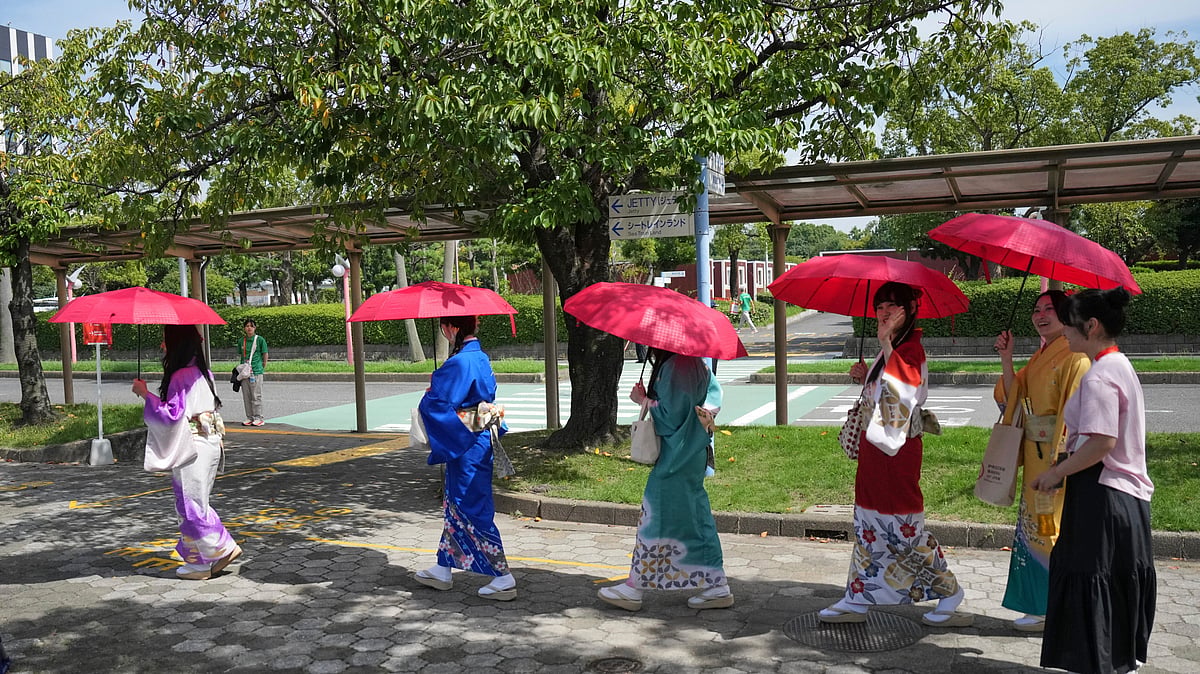 Women in traditional Japanese kimonos walk near the athletes village at the Asian Games in Nagoya, Japan, Friday, Sept. 18, 2026. - (AP Photo/Dita Alangkara)