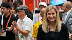 International Olympic Committee President, Kirsty Coventry, right, greets members of the media during a visit to the press centre at the Asian Games in Nagoya, Japan, Saturday, Sept. 19, 2026. - (AP Photo/Dita Alangkara)