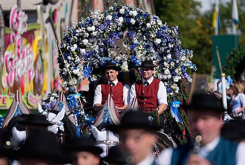 People wear traditional costumes in the Oktoberfest parade at the 191st Oktoberfest beer festival in Munich, Germany, Saturday, Sept.19, 2026. 