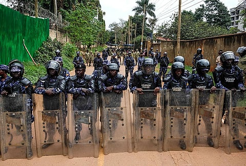 Police officers barricade the roads to the Turkish Embassy, following a protest by members of the Patriotic League of Uganda, demanding the extradition of a dissident, Fred Lumbuye, whose online activities are seen by local authorities as anti-government propaganda, in Kampala, Uganda, Friday, Sept. 18, 2026. 
