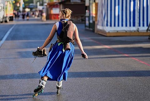 A waitresses skates to work prior to the opening of the 191st Oktoberfest beer festival in Munich, Germany, Saturday, Sept.19, 2026. 
