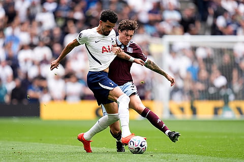 Tottenham Hotspur's Dominic Solanke, left, and Aston Villa's Victor Lindel of challenge for the ball during the English Premier League soccer match between Tottenham Hotspur and Aston Villa, at Tottenham Hotspur Stadium in London.