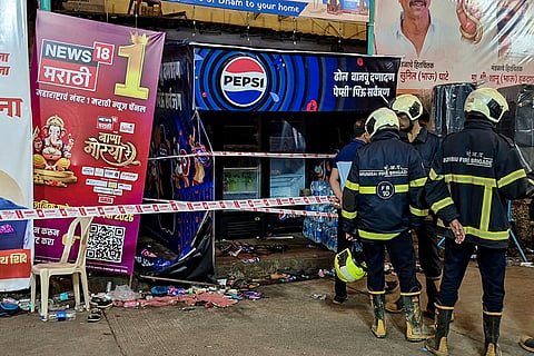 Rescue personnel stand near a sealed area after an electrocution incident near a Ganapati pandal, at Lalbaug area, in Mumbai. Two persons, including an eight-year-old girl, were killed and several others were injured in the incident.