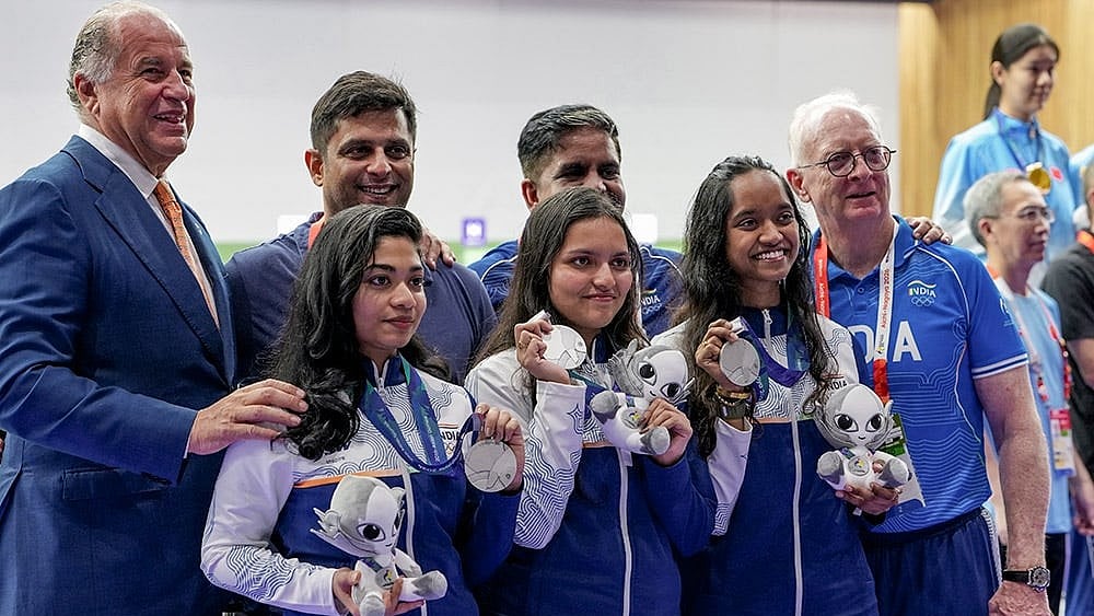 Front row from left, India's Vidarsa Vinod, Sonam Maskar and Elavenil Valarivan pose for photographers with others after winning silver medals in the 10m Air Rifle Women Team Final event during the 20th Asian Games, in Nagoya, Japan. - Photo: PTI/Atul Yadav