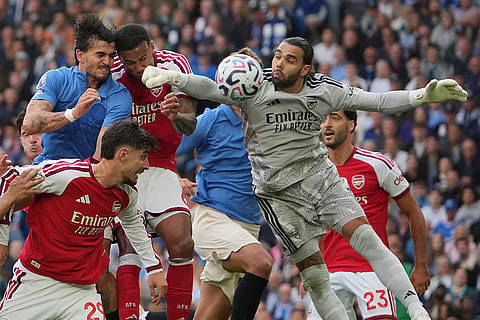 Arsenal's goalkeeper David Raya misses the ball during the English Premier League soccer match between Brighton & Hove Albion and Arsenal in Brighton, England.