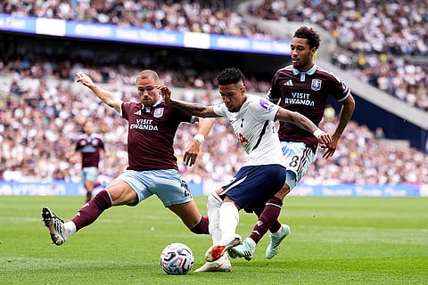 Tottenham Hotspur's Savio, center, is closed down by Aston Villa's Matty Cash, left, during the English Premier League soccer match between Tottenham Hotspur and Aston Villa, at Tottenham Hotspur Stadium in London.