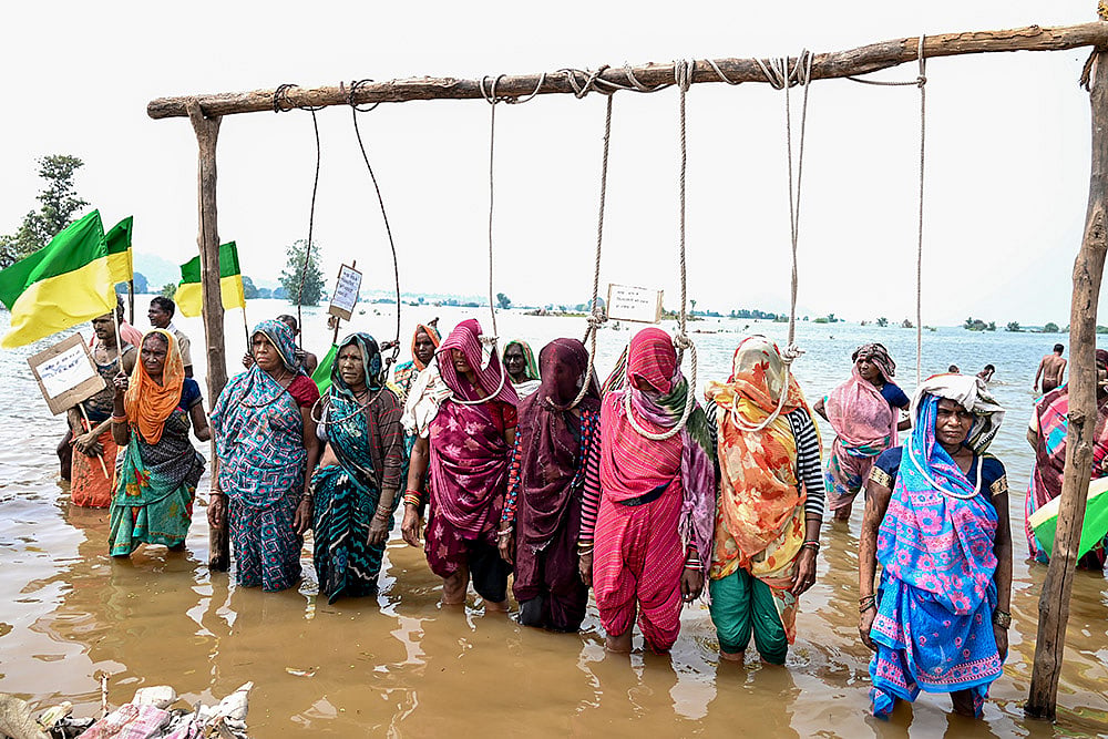| Photo: PTI  : Displaced villagers affected by the Ken-Betwa, Majhgawan, and Runjh river interlinking projects stage a symbolic Chita Andolan protest on funeral pyres to demand compensation and rehabilitation following home submersions, in Panna, Madhya Pradesh.