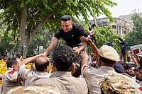 Day In Pics: September 20, 2026 | Photo: PTI : Activist Tehseen Punaawala being detained by police during a protest against the E20 policy, at Jantar Mantar in New Delhi.