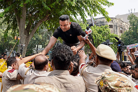 Activist Tehseen Punaawala being detained by police during a protest against the E20 policy, at Jantar Mantar in New Delhi.