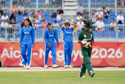 India's Shreyanka Patil, second left, Radha Yadav, left, and Nandani Sharma celebrate after a wicket during the second semifinal T20I cricket match between India’s women and Bangladesh’s women in the ongoing Asian Games 2026, at Aichi Prefectural Korogi Sports Park in Nisshin, Japan.
