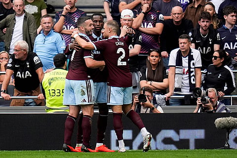 Aston Villa's Nicolas Jackson celebrates with teammates after scoring their side's second goal as Tottenham fans look on during the English Premier League soccer match between Tottenham Hotspur and Aston Villa, at Tottenham Hotspur Stadium in London.