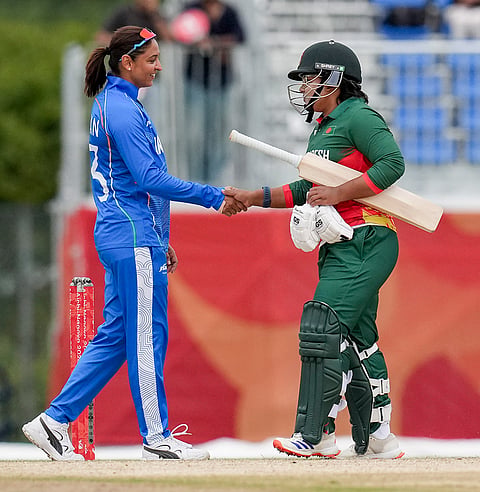 India's captain Harmanpreet Kaur, left, shakes hand after team's win in the second semifinal T20I cricket match between India’s women and Bangladesh’s women in the ongoing Asian Games 2026, at Aichi Prefectural Korogi Sports Park in Nisshin, Japan.