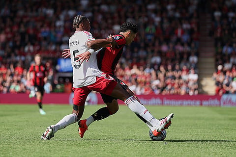 Liverpool's Jeremy Jacquet, left, tackles Bournemouth's Evanilson during the English Premier League soccer match between Bournemouth and Liverpool in Bournemouth, England.