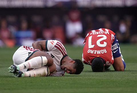 Real Madrid's Jude Bellingham and Atletico Madrid's Cristian Romero grimace on the ground after a collision during a Spanish La Liga soccer match between Atletico Madrid and Real Madrid in Madrid, Sunday, Sept. 20, 2026. 