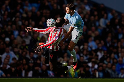 Manchester City's Ruben Dias, right, fouls Sunderland's Brian Brobbey during the English Premier League soccer match between Manchester City and Sunderland in Manchester, England.