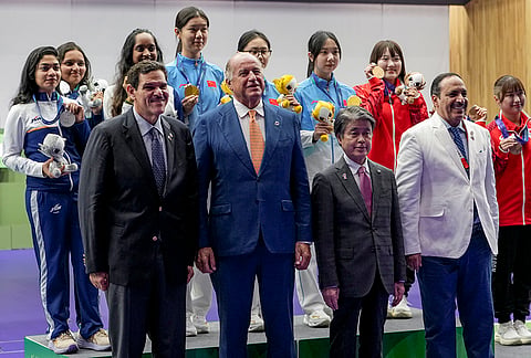 Gold medallists China's Wang Zifei, Du Yuchen and Han Jiayu, silver medallists India's Vidarsa Vinod, Sonam Maskar and Elavenil Valarivan and bronze medallists Japan's Misaki Nobata, Hinata Taichi and Shiori Hirata pose for photographers with others after the 10m Air Rifle Women Team Final event during the 20th Asian Games, in Nagoya, Japan, Sunday, Sept. 20, 2026.
