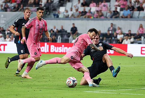 Inter Miami forward Lionel Messi, second from right, battles for the ball with San Diego FC defender Kieran Sargeant, right, during the first half of an MLS soccer game, Sunday, Sept. 20, 2026, in Miami. 