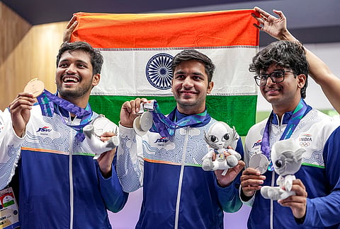 India’s Himanshu Dhillon, centre, Rudrankksh Patil, left, and Parth Rakesh Mane pose for photographs after wiining silver medal in the 10 meter rifle men team event in the ongoing 20th Asian Games 2026, in Nagoya, Japan, Monday, Sept. 21, 2026.