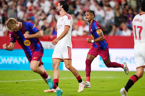 Barcelona's Raphinha, centre right, celebrates after scoring his side's first goal the Spanish La Liga soccer match between Sevilla and Barcelona in Seville, Spain.