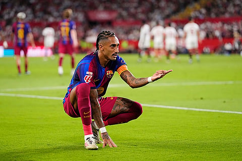 Barcelona's Raphinha celebrates after scoring his side's second goal the Spanish La Liga soccer match between Sevilla and Barcelona in Seville, Spain.
