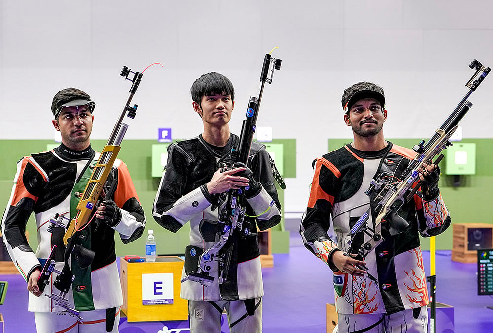 China's Sheng Lihao, Gold medal, centre, India’s Himanshu Dhillon, Silver medal, left, and Rudrankksh Patil, Bronze medal pose for photographs after the 10 meter rifle men individual event in the ongoing 20th Asian Games 2026, in Nagoya, Japan, Monday, Sept. 21, 2026.  - | Photo: PTI/Atul Yadav
