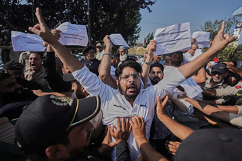 Police officers try to stop supporters of the Jammu Kashmir Apni Party as they hold placards that reads, "We don't want promises or excuses. We want justice in reservation," during a protest demanding jobs, opposing a power tariff hike and pressing other demands in Srinagar, Kashmir.