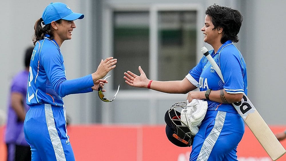 India’s Shafali Verma, right, with Smriti Mandhana celebrates her century during the second semifinal T20I cricket match between India’s women and Bangladesh’s women in the ongoing Asian Games 2026, at Aichi Prefectural Korogi Sports Park in Nisshin, Japan. - Photo: PTI/Arun Sharma