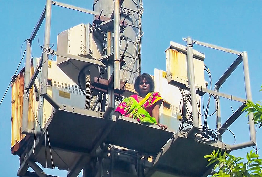 A woman climbs a mobile tower in Lucknow