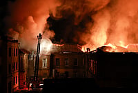 In Photos: Russian Drone Barrage Hits Zaporizhzhia After Kyiv Attacks | Photo: AP/Kateryna Klochko : A rescue worker puts out a fire at the 120-year-old historic building of Zaporizhzhia National University after a Russian drone strike on Zaporizhzhia, Ukraine, Monday, Sept. 21, 2026.