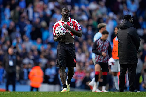 Sunderland's Brian Brobbey carries the ball after scoring a hat trick, after the English Premier League soccer match between Manchester City and Sunderland in Manchester, England.