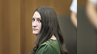 Greg Derr/The Patriot Ledger via AP, Pool : Lindsay Clancy watches jury members as Judge William Sullivan polls them during her murder trial at Plymouth Superior Court in Plymouth