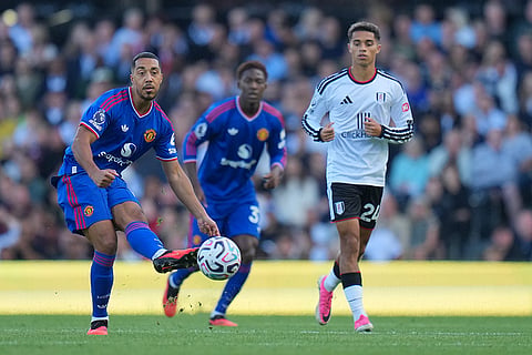 Manchester United's Youri Tielemans, left, kicks the ball during the English Premier League soccer match between Fulham and Manchester United in London.