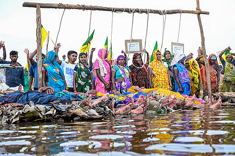 Displaced villagers affected by the 'Ken-Betwa', 'Majhgawan', and 'Runjh' river interlinking projects stage a symbolic 'Chita Andolan' protest on funeral pyres to demand compensation and rehabilitation following home submersions, in Panna, Madhya Pradesh, Saturday, Sept. 19, 2026.