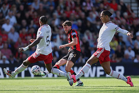 Bournemouth's Ryan Christie, center, takes a shot at goal during the English Premier League soccer match between Bournemouth and Liverpool in Bournemouth, England.