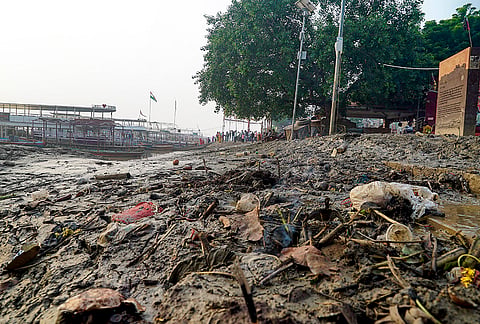 Mud, debris and discarded items piled up after the floodwaters receded on the ghats, in Varanasi