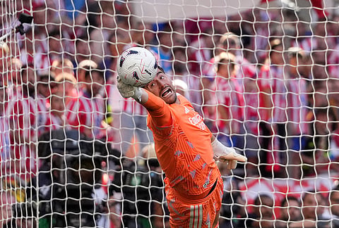 Real Madrid's goalkeeper Thibaut Courtois makes a save during a Spanish La Liga soccer match between Atletico Madrid and Real Madrid in Madrid, Sunday, Sept. 20, 2026. 