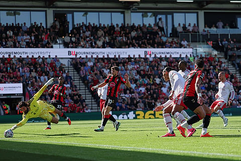 Liverpool's goalkeeper Alisson makes a save during the English Premier League soccer match between Bournemouth and Liverpool in Bournemouth, England.